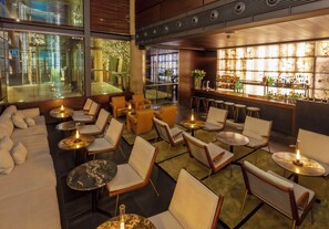 A modern bar area with seating and a bar counter.