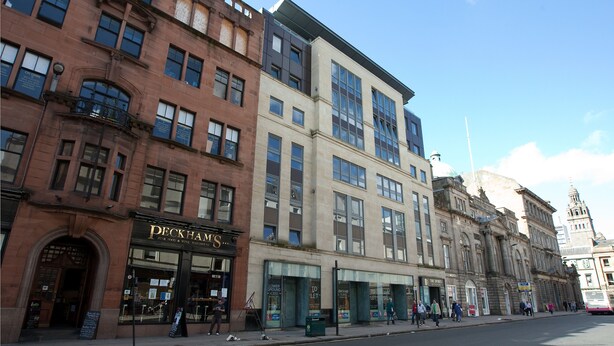 A row of multi-story buildings with various storefronts, including a Peckham's restaurant. - The Spires Serviced Apartments Glasgow (Glasgow)