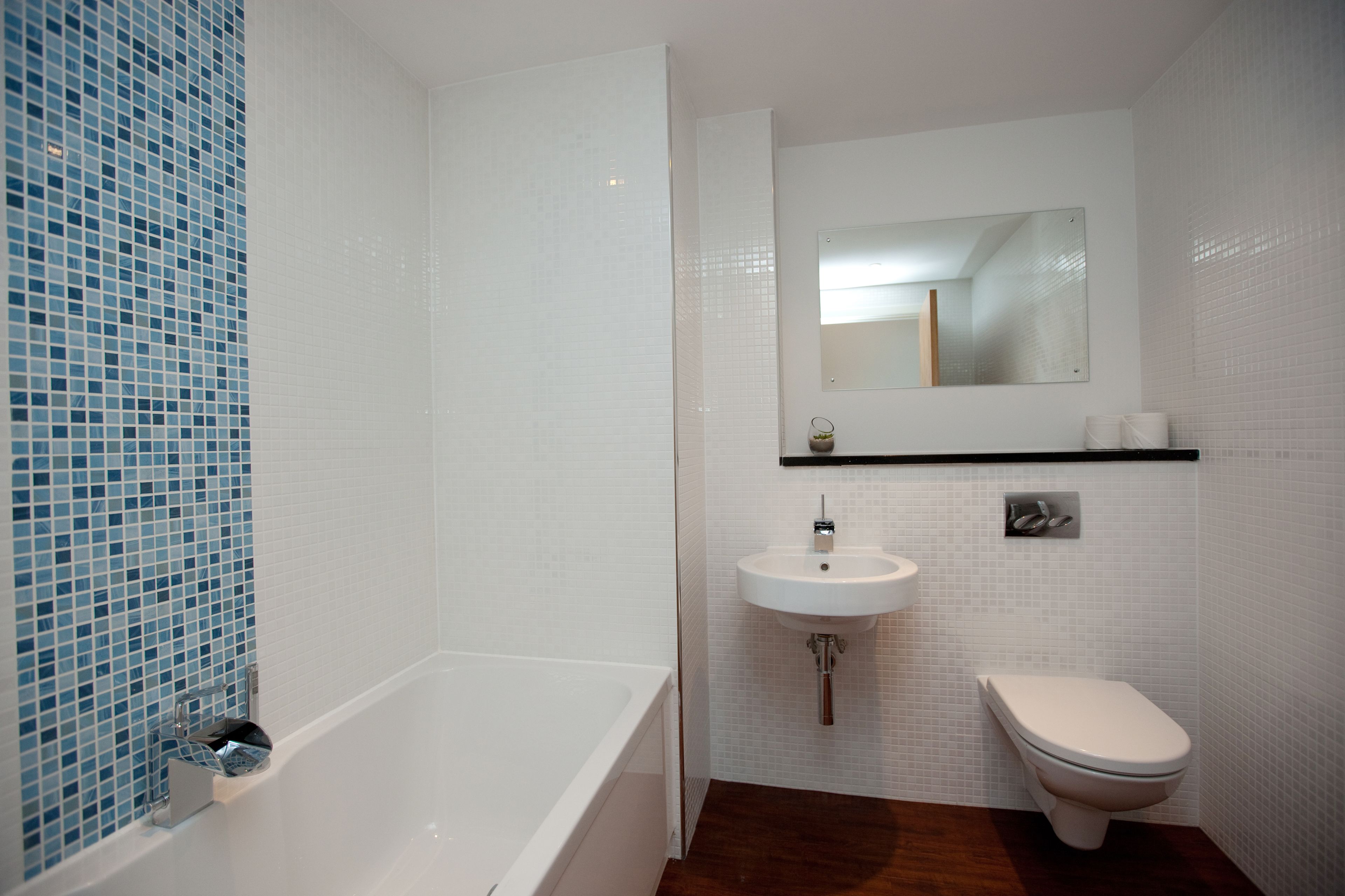 A bathroom with a bathtub, sink, and toilet.