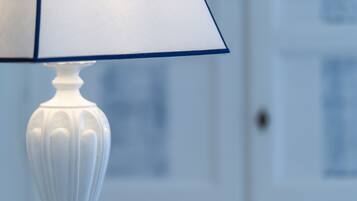 A white table lamp with a blue shade.