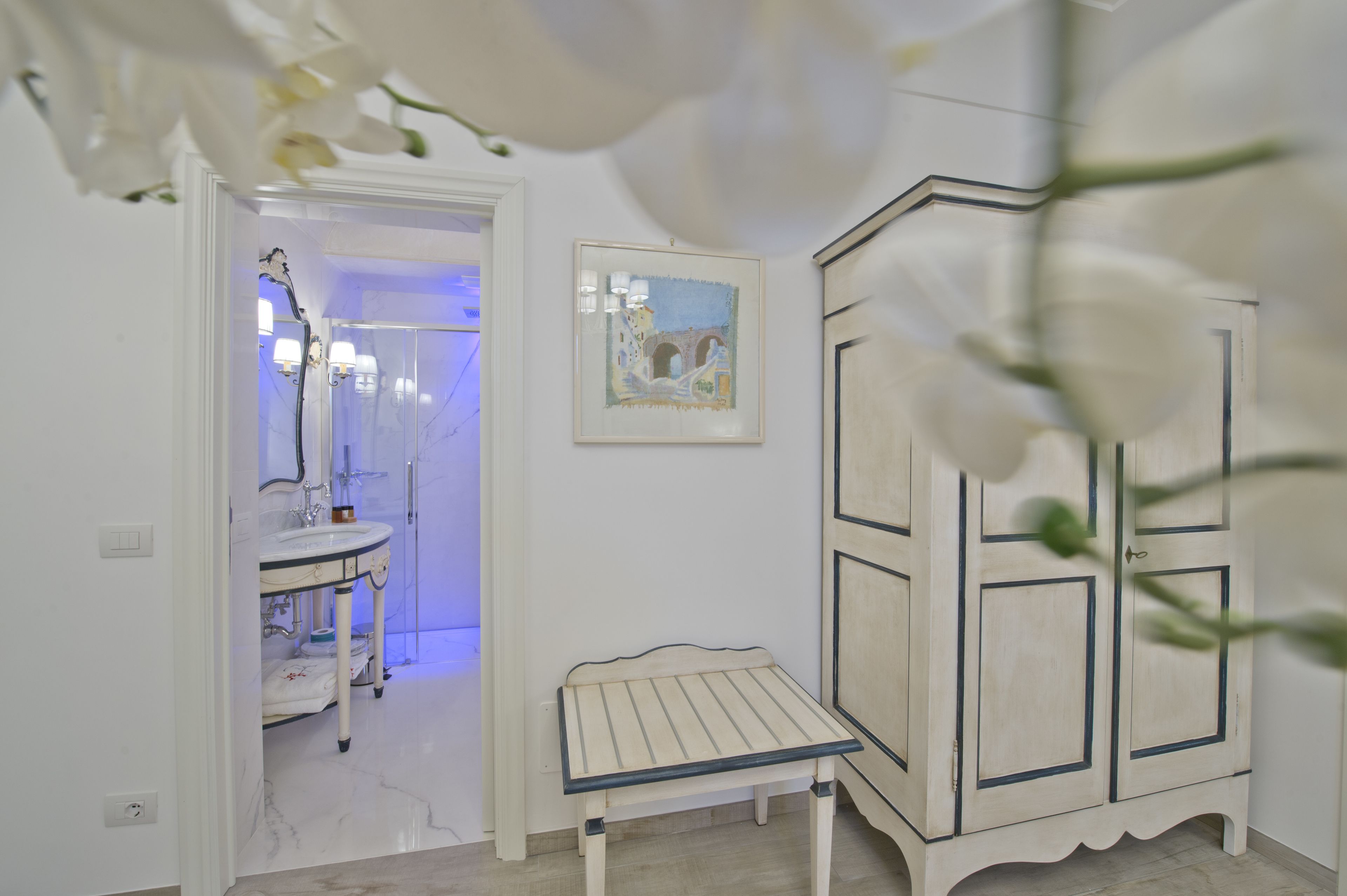 A bathroom with a white sink, a mirror, and a cabinet.