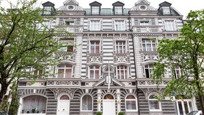A historic building with ornate architectural details, including multiple balconies and a prominent entrance with a sign reading "HOTEL OPERA". - Opera Hotel (Munich)