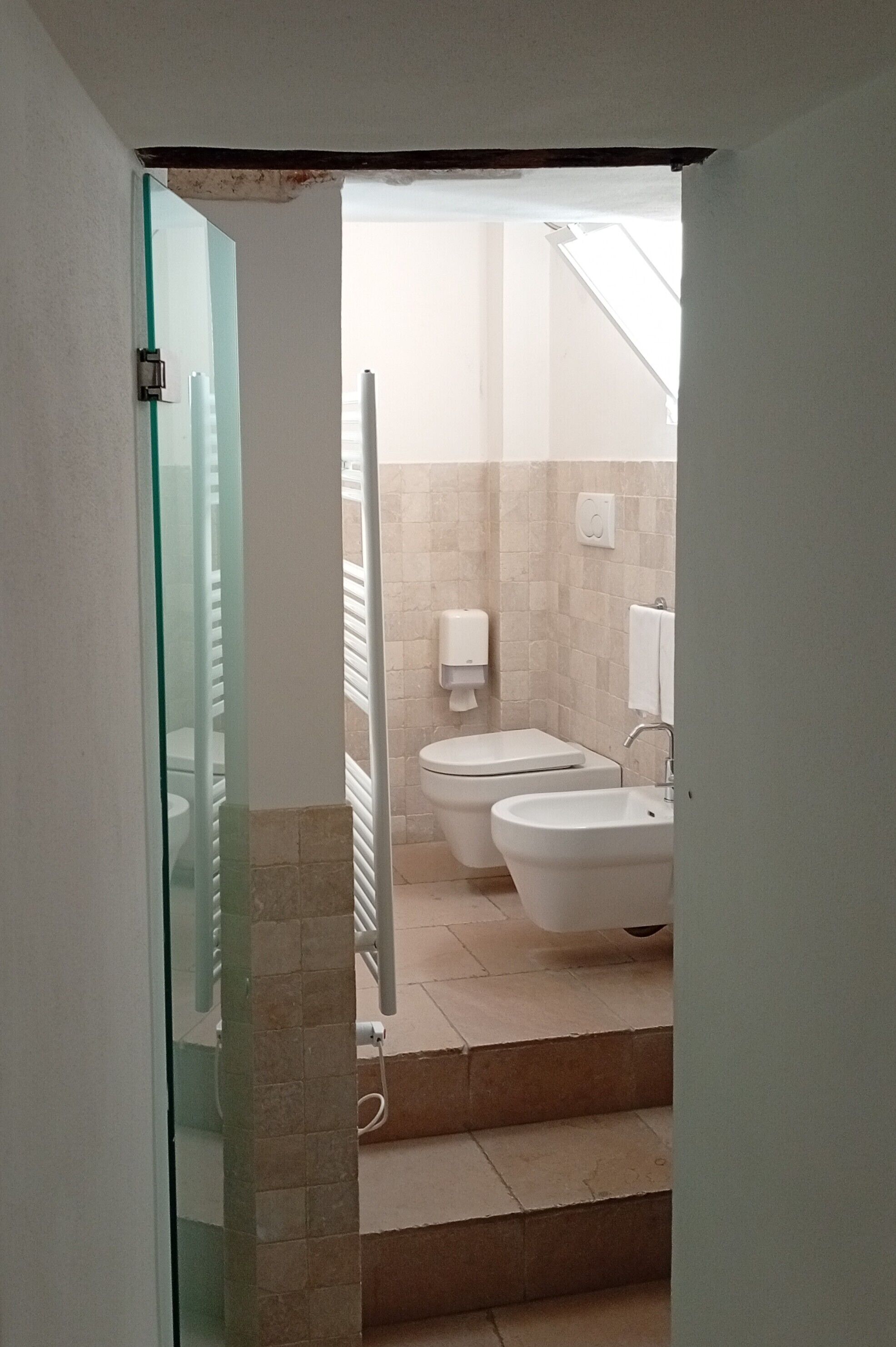 A bathroom with a toilet, bidet, and sink.