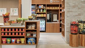 A grocery store interior with shelves stocked with snacks, a refrigerated section, and a freezer. - Hilton Garden Inn Kitchener/Cambridge (Cambridge)