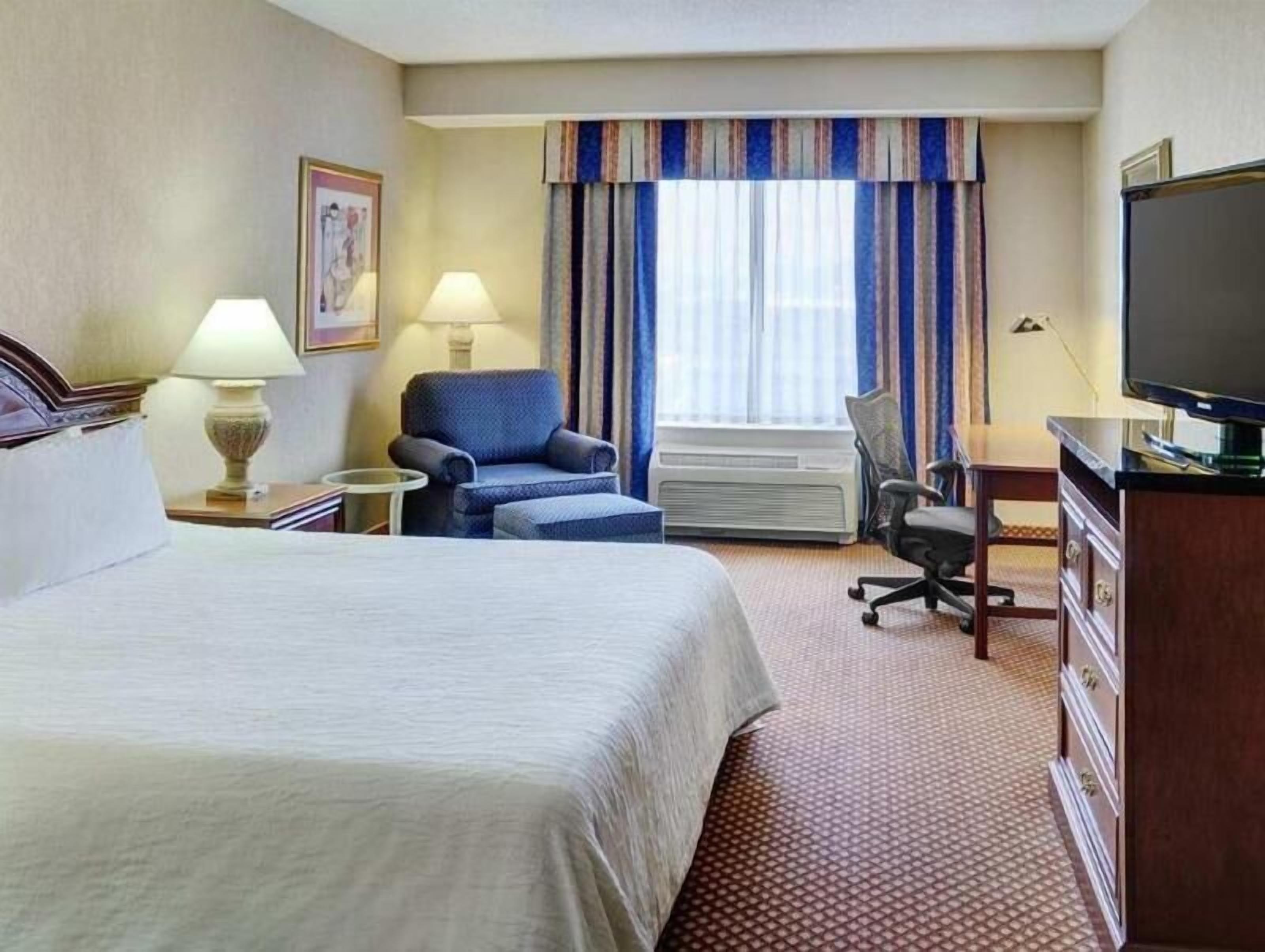 Hypo-allergenic bedding, desk, laptop workspace, blackout curtains