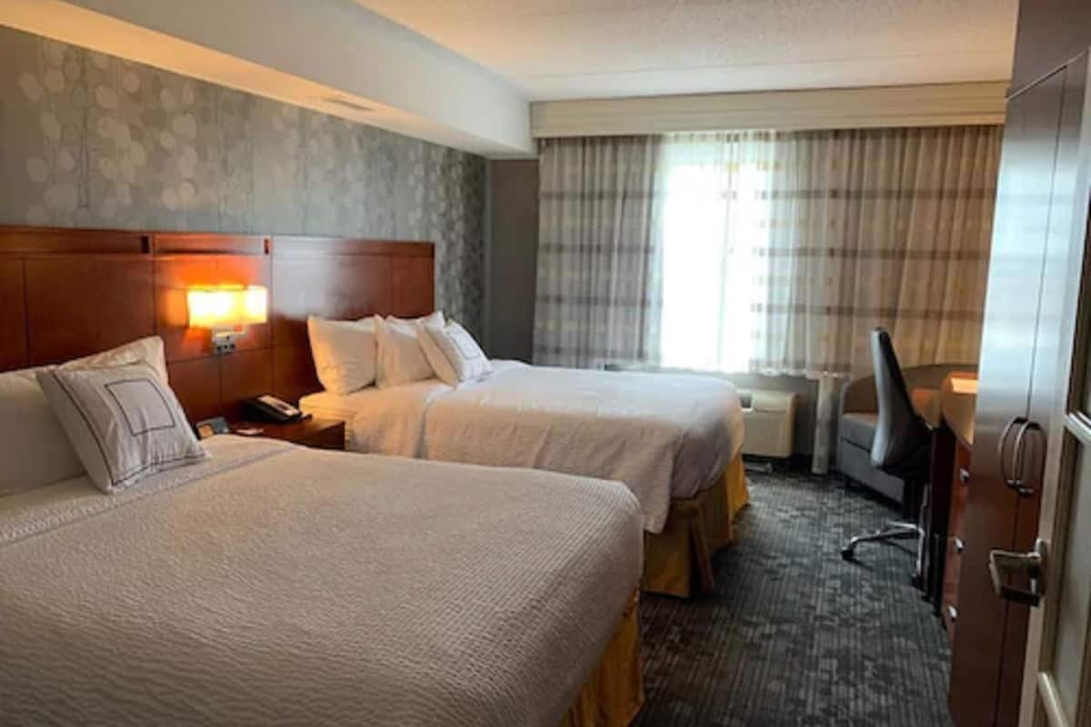 hypo-allergenic bedding, desk, laptop workspace, blackout curtains