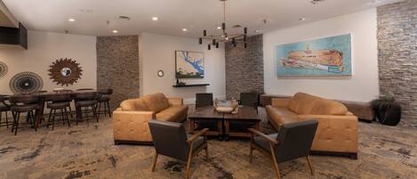 A modern living room with leather sofas, a coffee table, and a dining area with chairs and a table.