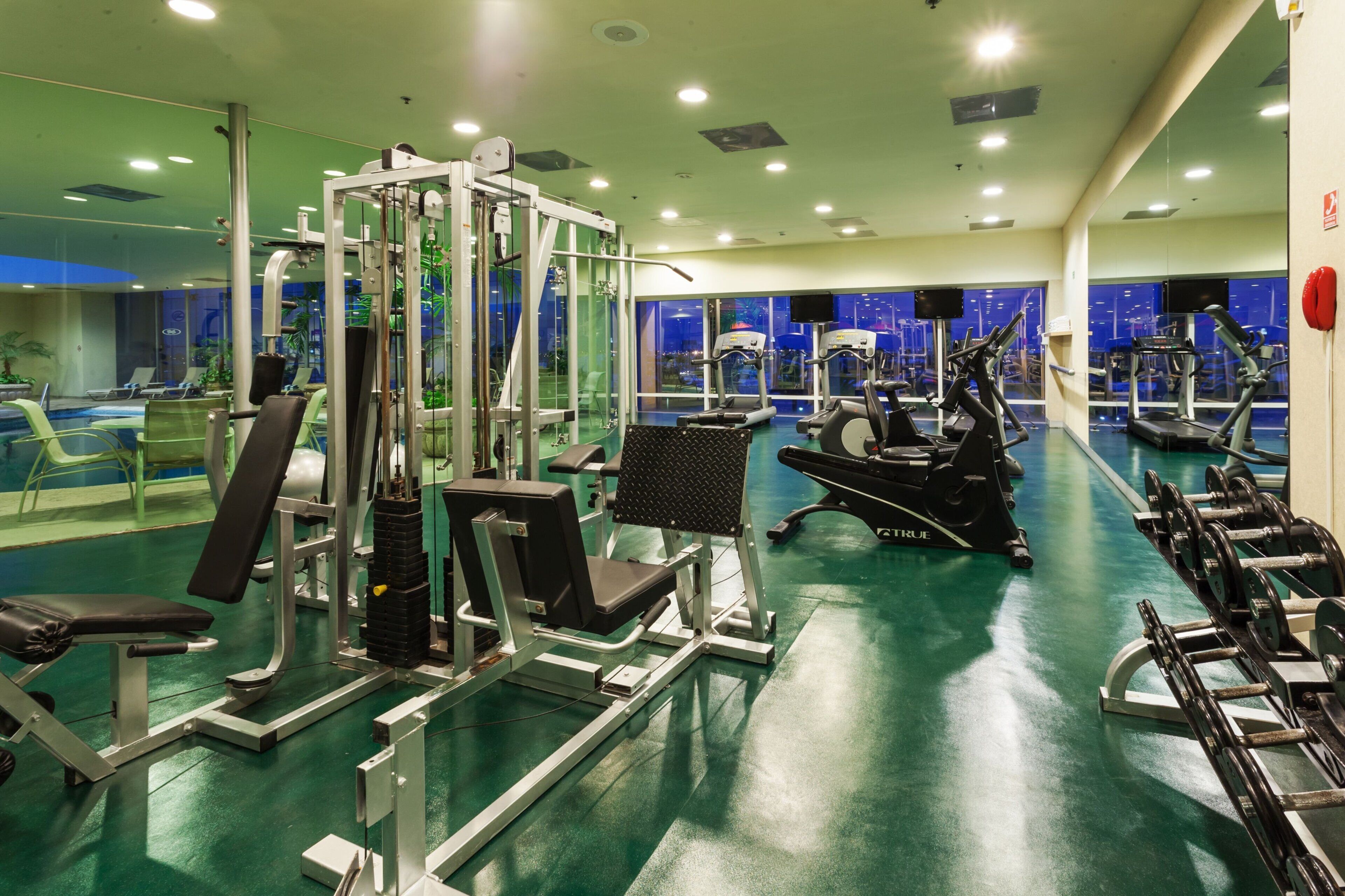 A gym with various exercise equipment, including treadmills and weight machines.