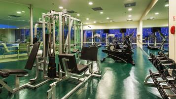 A gym with various exercise equipment, including treadmills and weight machines.