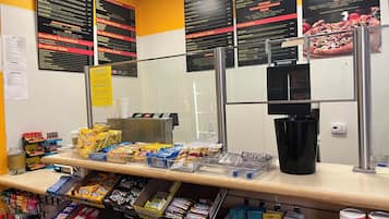 A breakfast counter with various food items and a menu.