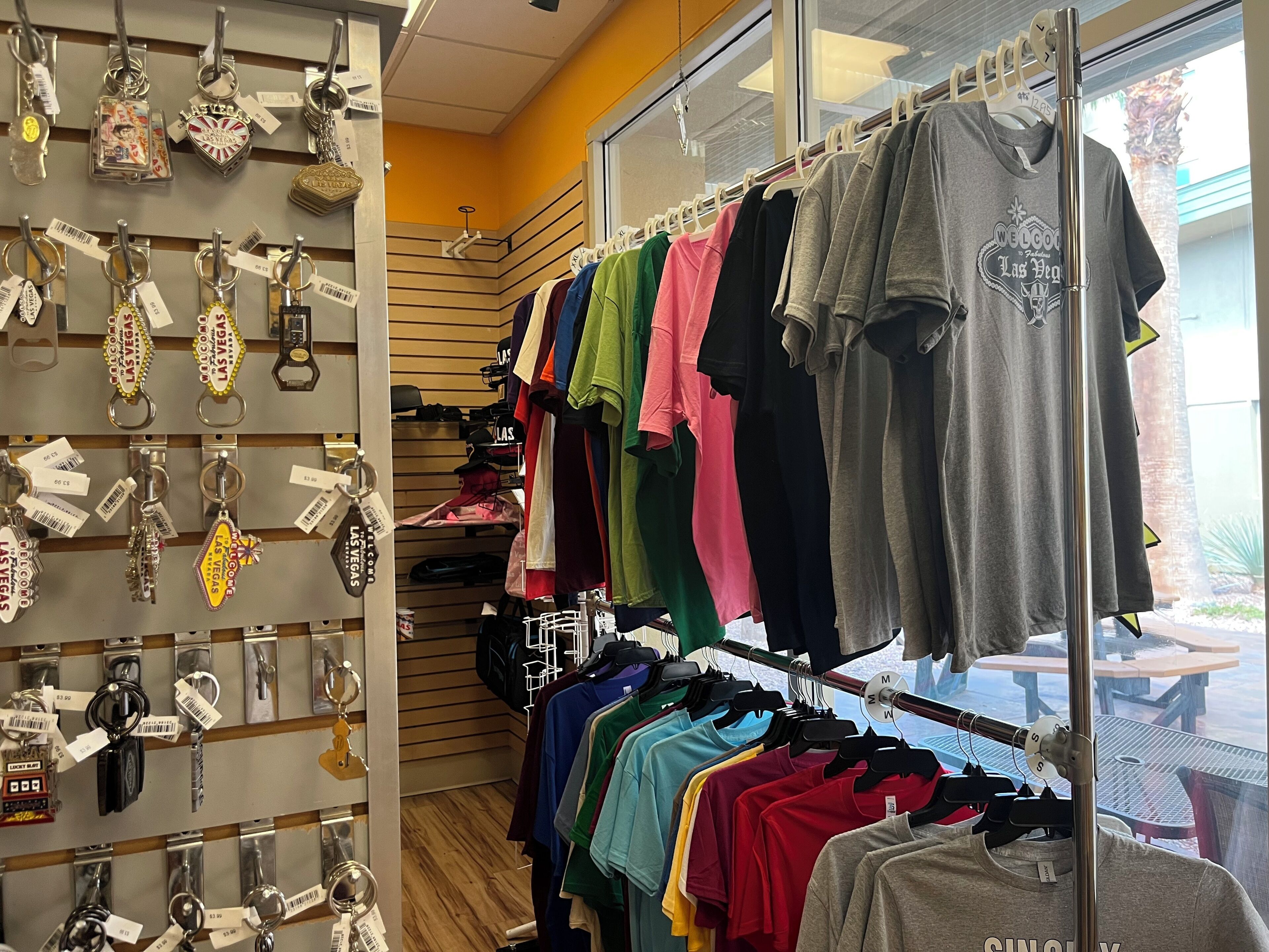 A retail store with keychains and t-shirts on display.