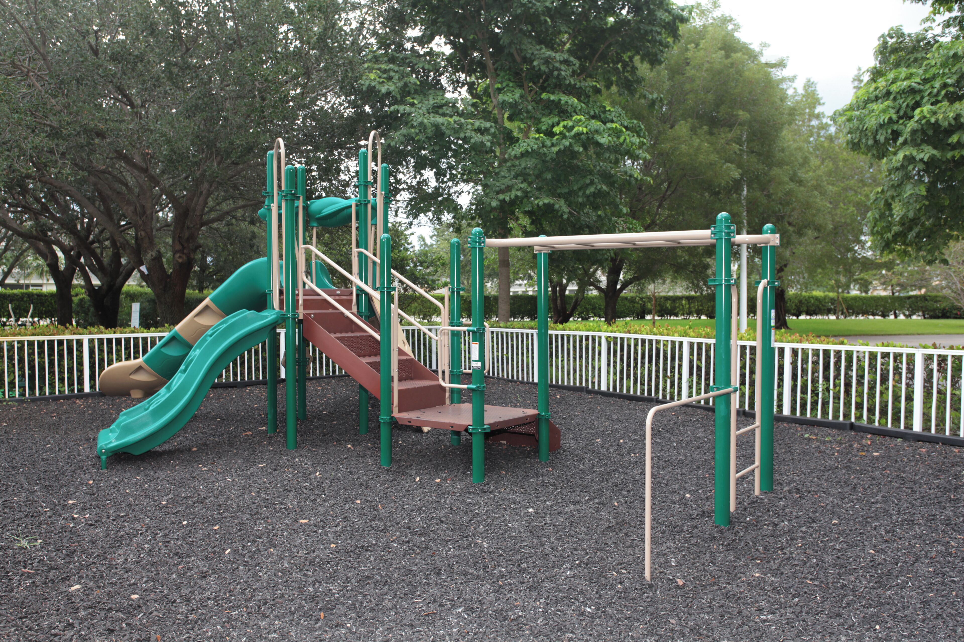 A playground with a slide, stairs, and climbing structures.
