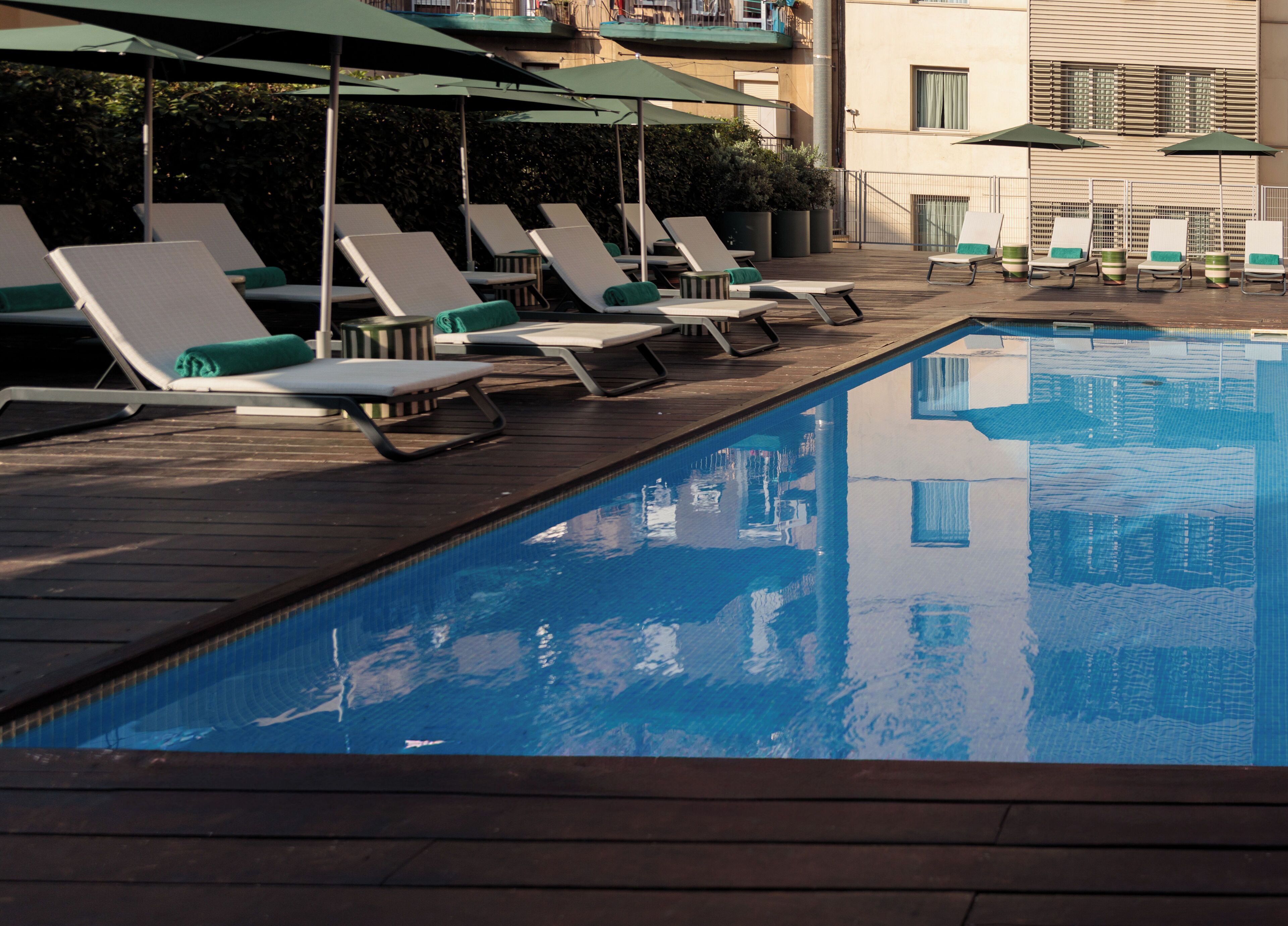 Seasonal outdoor pool, open 10:00 AM to 8:00 PM, pool umbrellas