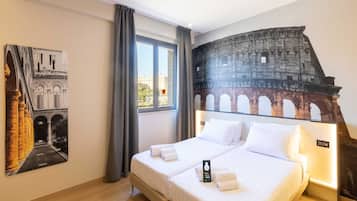 A hotel room with a large bed, a window with curtains, a headboard with a cityscape mural, and a framed picture on the wall.