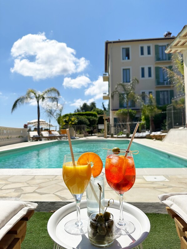 Seasonal outdoor pool, open 10:00 AM to 8:00 PM, pool umbrellas