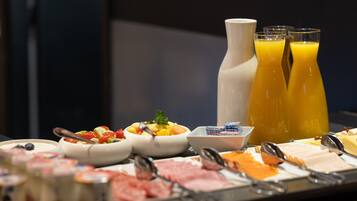 A buffet with various food items and beverages.