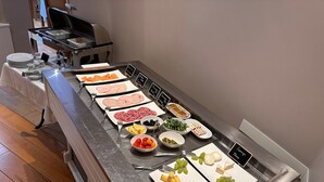A buffet table with various food items and utensils. - Maison Lutetia R (Strasbourg)