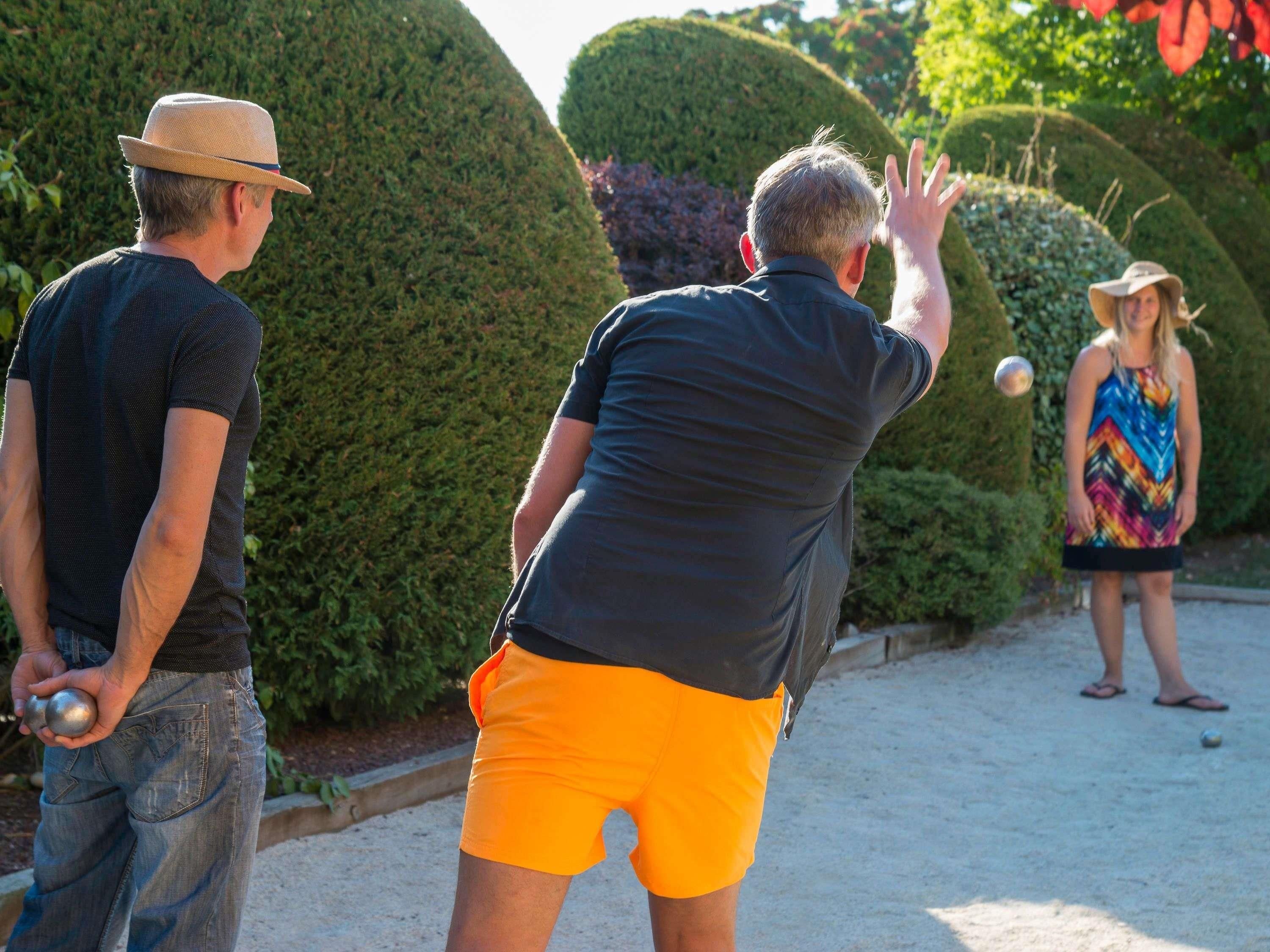 A group of people playing a ball game outdoors.