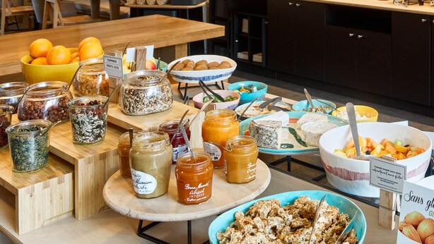 A buffet with various food items including fruits, nuts, and spreads.