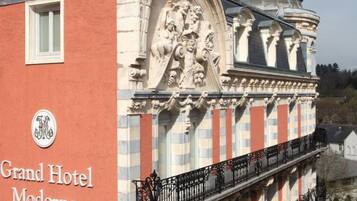 The Grand Hotel Moderne with a classic architectural style, featuring a prominent dome and detailed facade.
