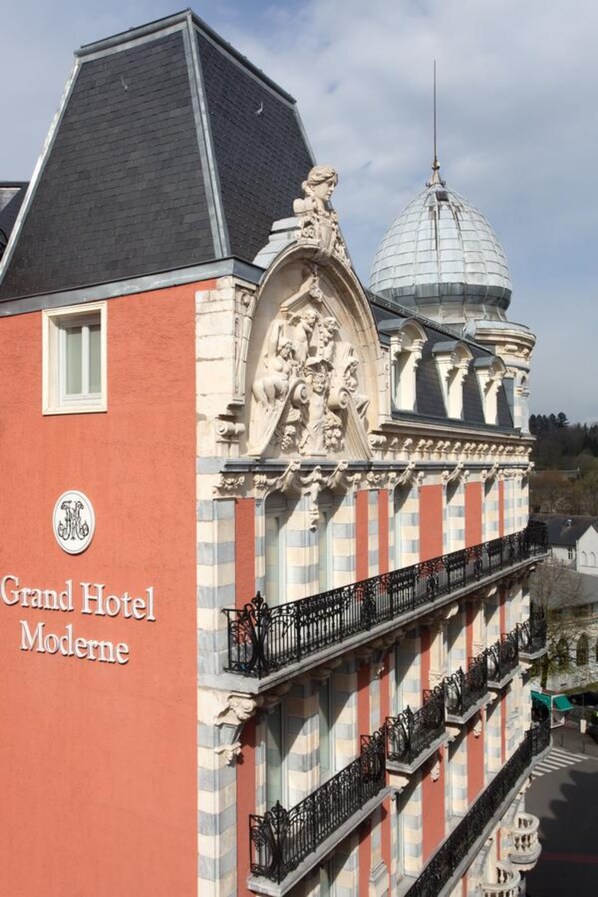 The Grand Hotel Moderne with a classic architectural style, featuring a prominent dome and detailed facade.