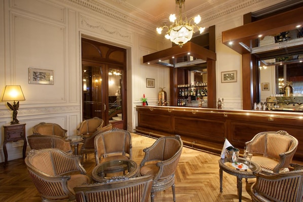 A bar area with wicker chairs and a bar counter.