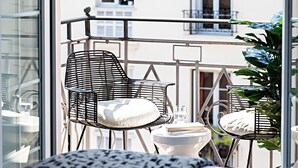 A balcony with metal chairs, a small table, and a potted plant. - Le Riviera Collection, BW Signature Collection (Nice)