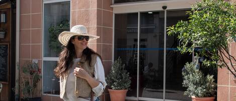 A hotel named HOTEL ESTEREL with a brick facade and large windows.