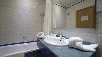 Ein Badezimmer mit Badewanne, Waschbecken und Dusche.