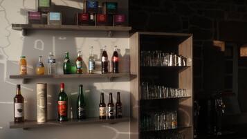 A bar area with shelves of bottles and glasses.