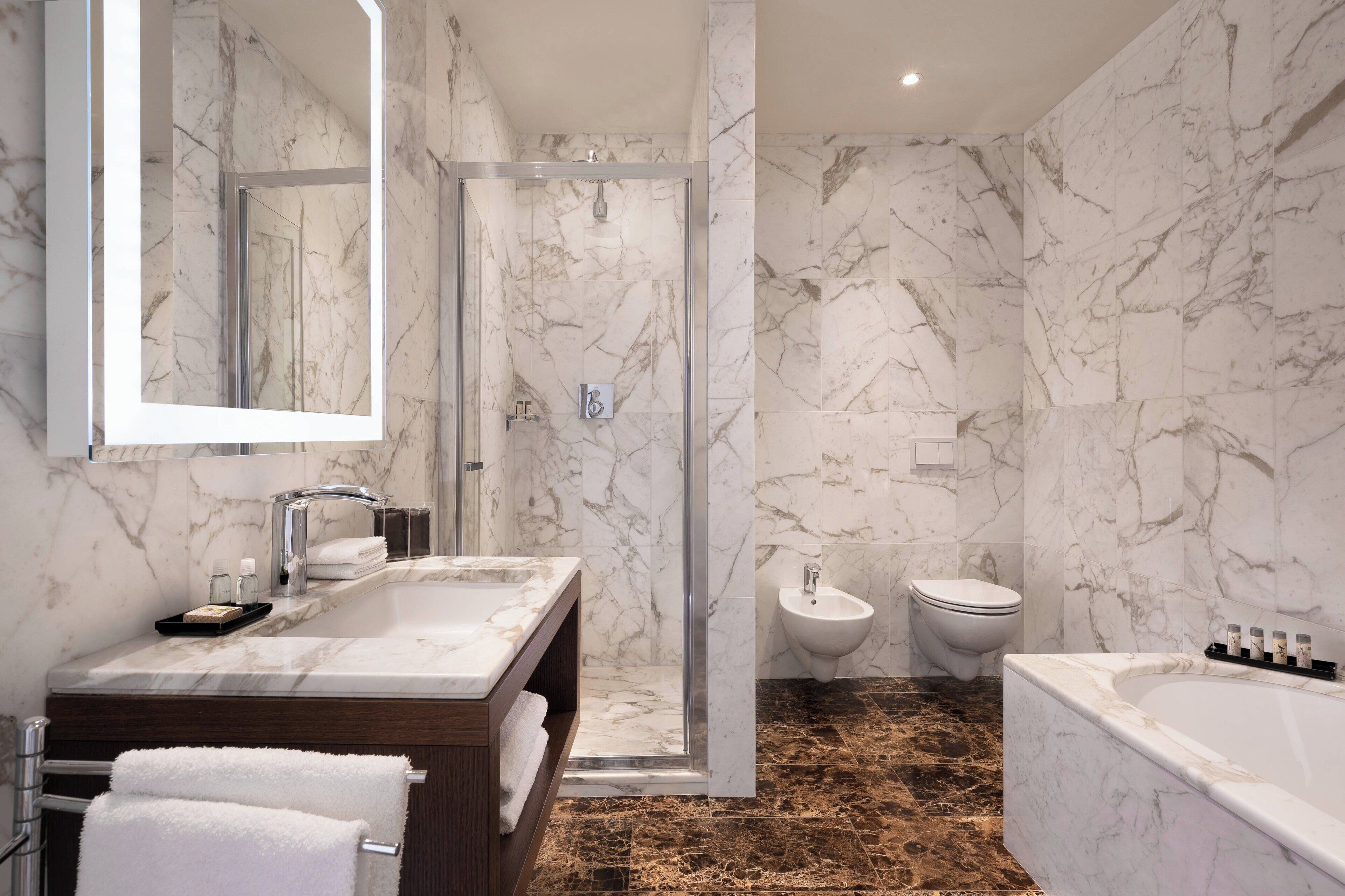 designer toiletries, hair dryer, bidet, towels