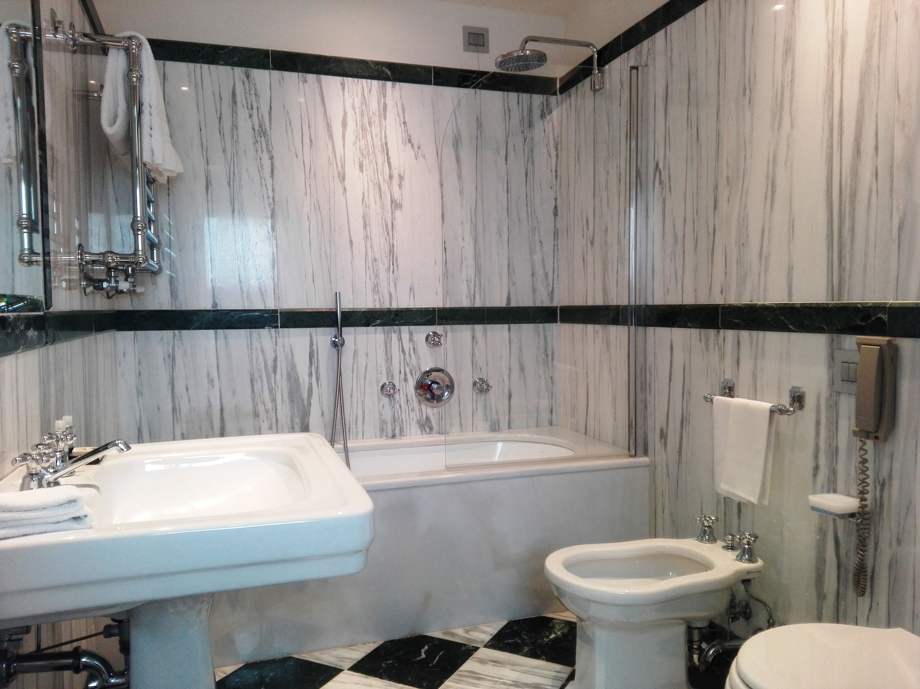 A bathroom with a bathtub, a sink, and a toilet.