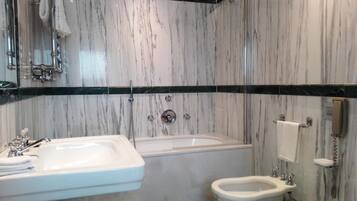 A bathroom with a bathtub, a sink, and a toilet.