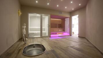 Relax in style with a spacious room featuring a large bathtub, bench, and sliding glass door leading to an outdoor space.