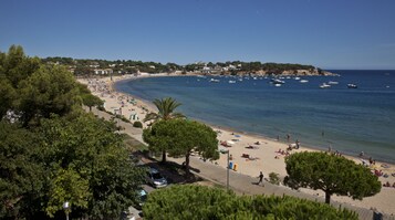 On the beach, white sand, beach towels, beach bar