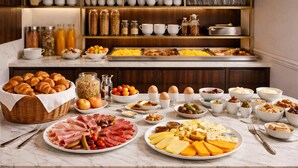 A breakfast buffet with various food items and condiments. - Hôtel Beauvoisin (Paris)