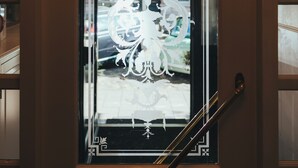 A door with a frosted glass panel featuring a decorative design. - Boutique Hotel Asterisk, a family run hotel (Amsterdam)
