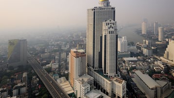 A high-rise building with a prominent dome and adjacent modern structures.