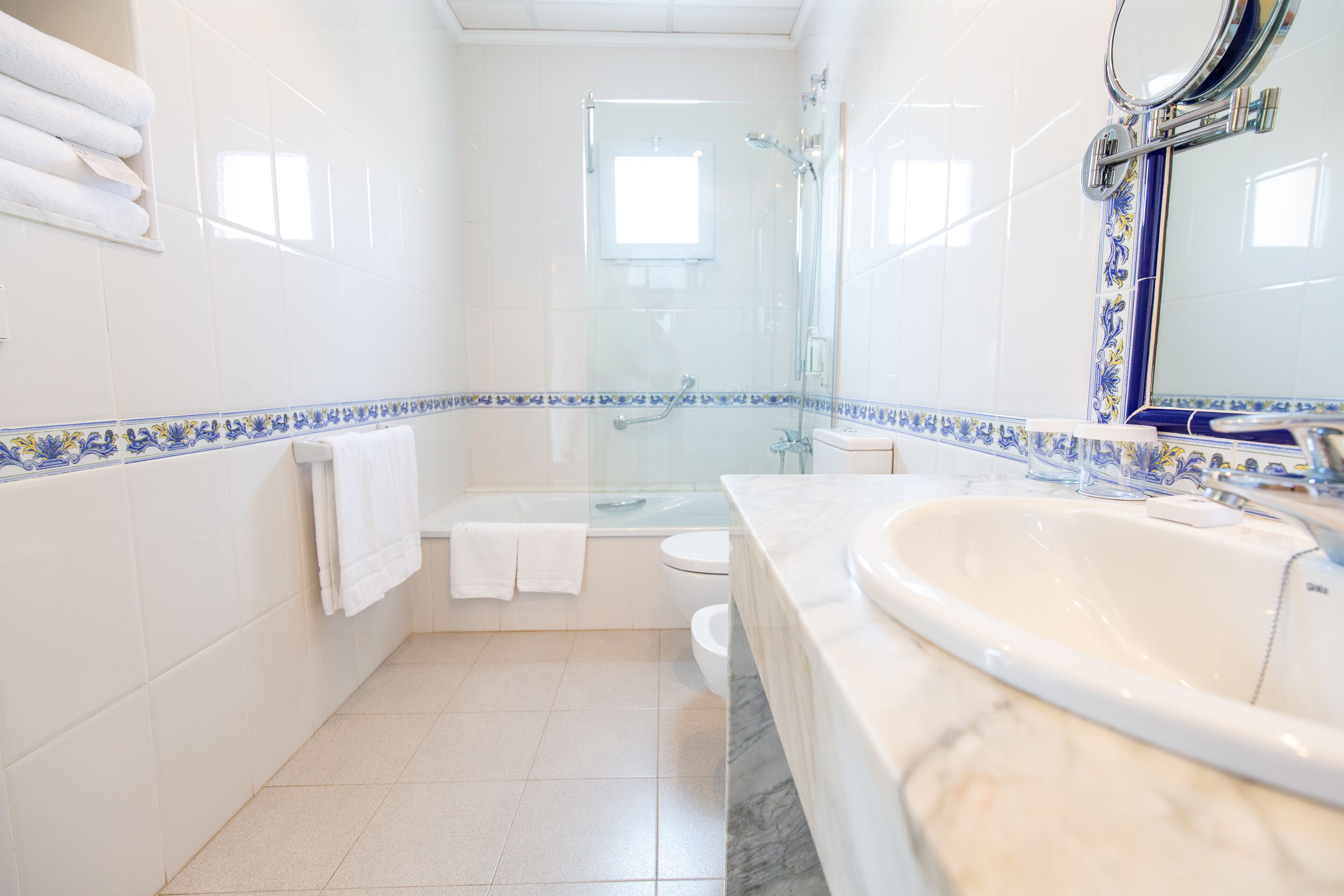 A bathroom with a bathtub, toilet, and shower.