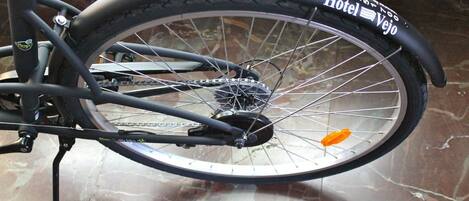 A bicycle with a black tire and a sticker that reads "Hotel Vejo."