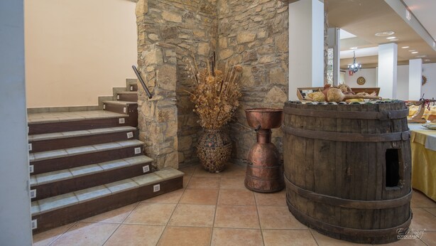 A stone wall, a wooden barrel, and a staircase.