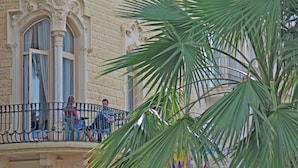 A building with ornate architectural details, including a balcony with a wrought iron railing. - Hotel Celimar (Sitges)