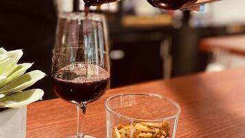 A person pouring wine into a glass.