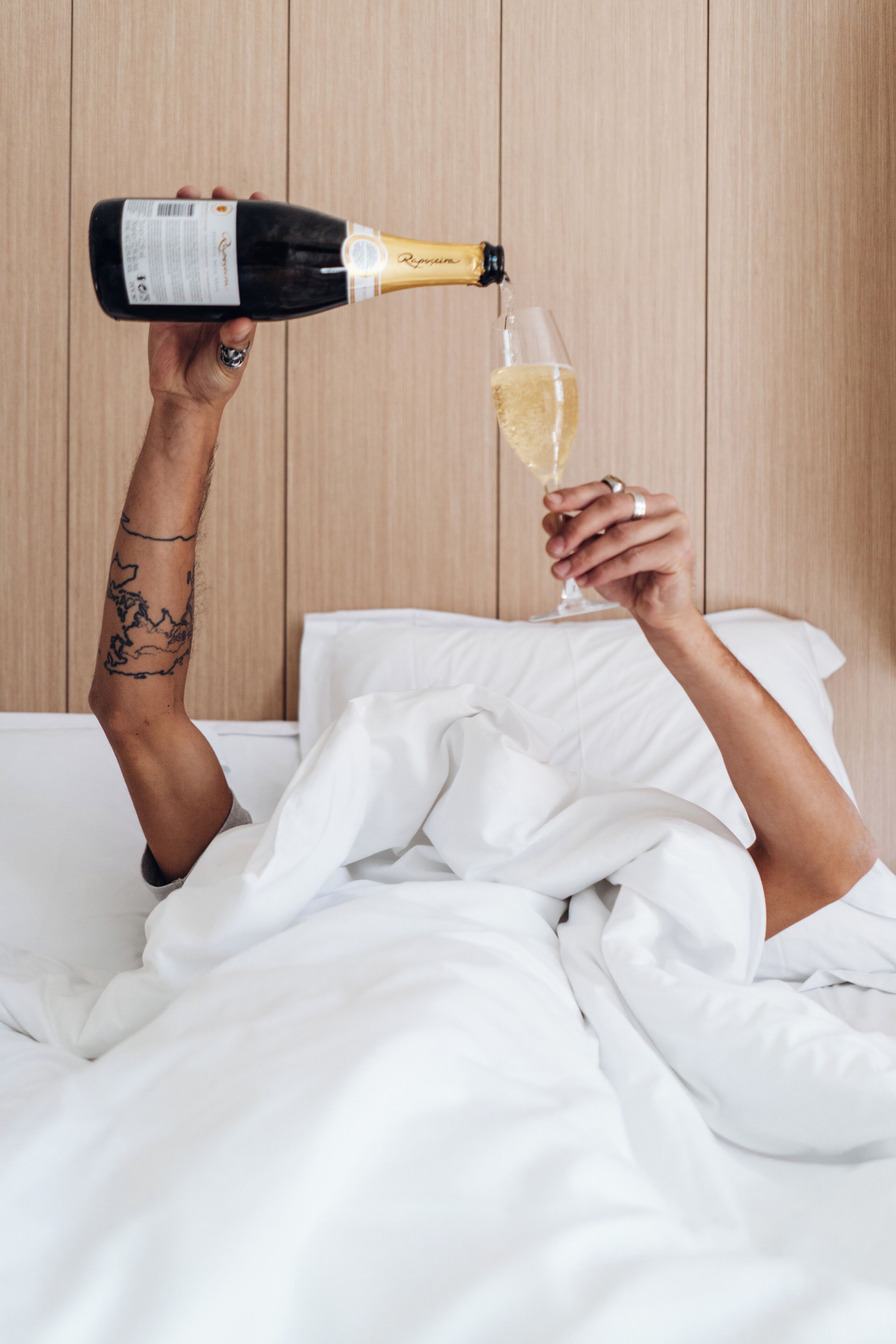 A person pouring champagne into a glass.