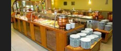 A buffet area with various food items and containers.