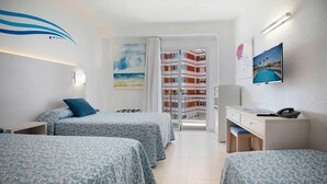A hotel room with two beds, a desk, a chair, a TV, and a balcony with a view of a building. - Hotel Servigroup Trinimar (Benicassim)