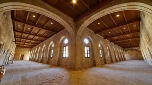 A spacious hall with arched ceilings and stone walls, featuring multiple windows and a central open area. - Eurostars Monumento Monasterio de San Clodio Hotel (Leiro)
