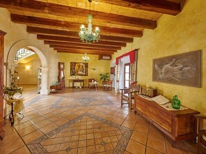Experience the perfect blend of traditional and modern elements in this beautifully appointed room, featuring a stunning chandelier, patterned tiles, and a cozy rug.