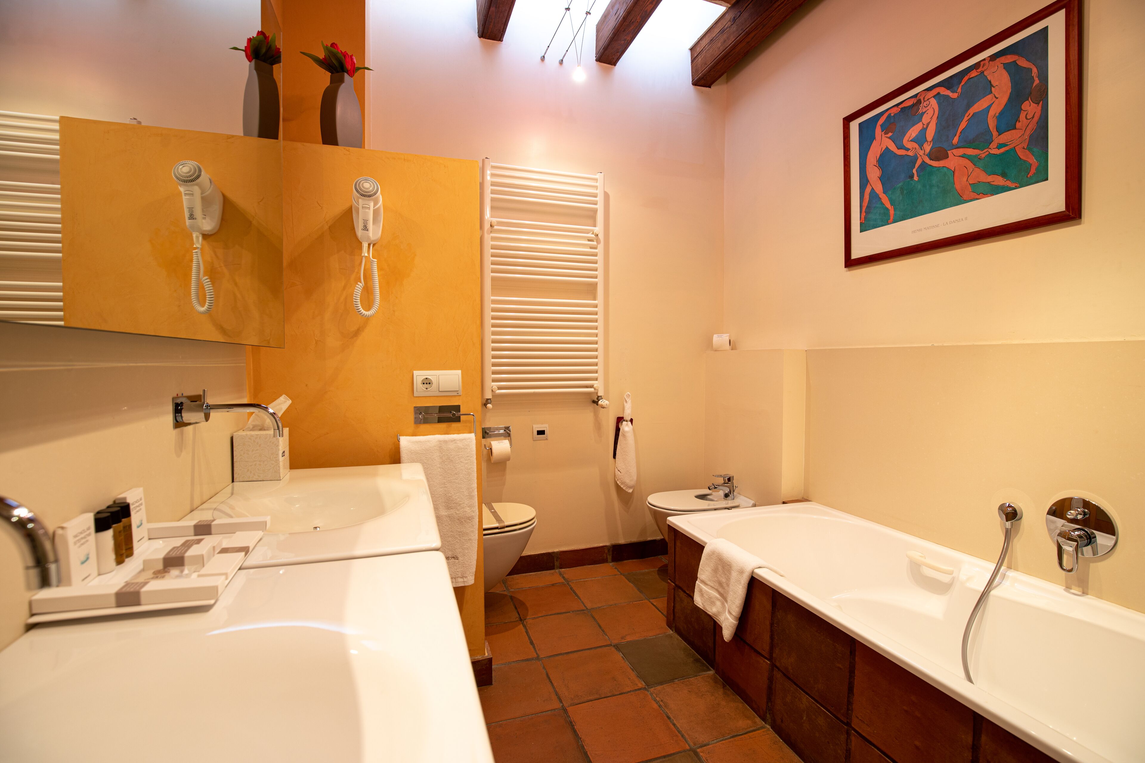 A bathroom with two sinks, a toilet, a bathtub, and a shower.