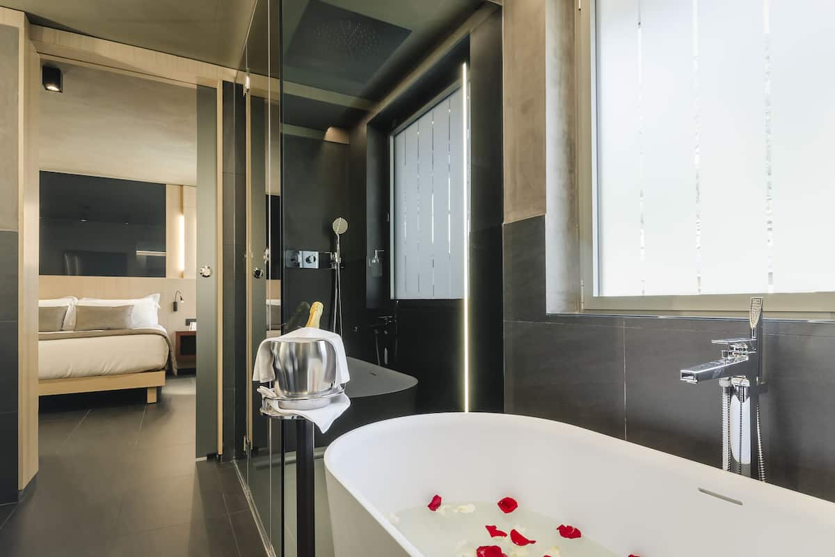 premium room, 1 king bed | bathroom | free toiletries, hair dryer, slippers, towels